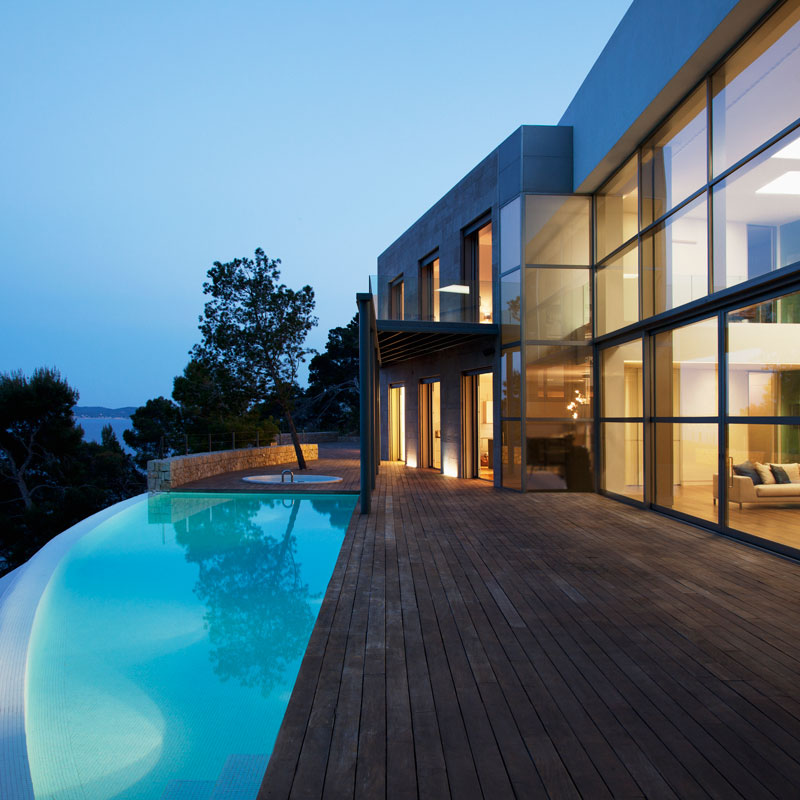 house at night with a pool